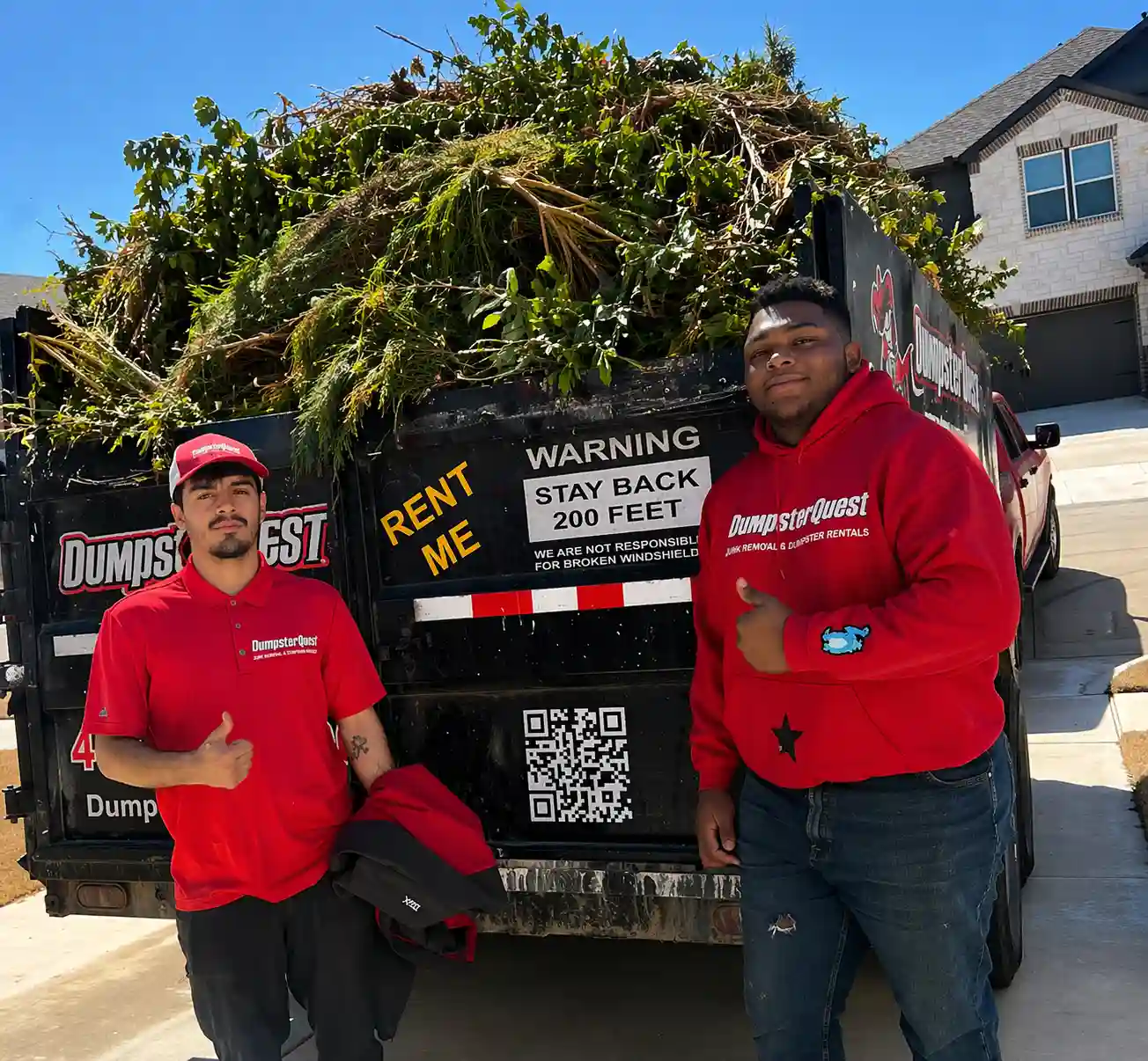 yard waste dumpster filled with branches and landscaping debris