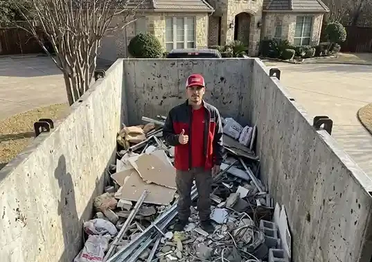 roll off concrete dumpster filled with heavy debris at construction site